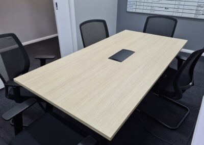 Toro meeting room table in seasoned Oak with black frame and comms box